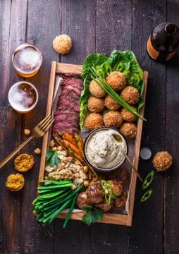 Assorted middle eastern dishes: falafel, meat, potato, cauliflower and Stock Photos