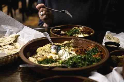 Assorted Middle Eastern dishes including hummus, baba ghanoush, tabbouleh, sa Stock Photos