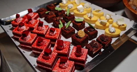 Assorted mini desserts on buffet tray at event Stockbeeldmateriaal 335061890