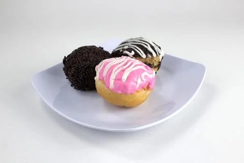 Assorted Mini Donuts with Chocolate and Pink Glaze on White Plate Isolated .. Stock Photos
