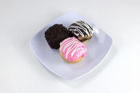 Assorted Mini Donuts with Chocolate and Pink Glaze on White Plate Isolated .. Stock Photos