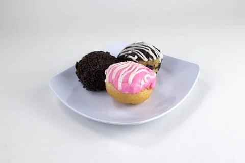 Assorted Mini Donuts with Chocolate and Pink Glaze on White Plate Isolated .. Stock Photos