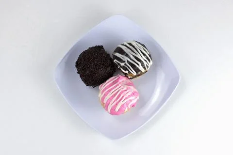 Assorted Mini Donuts with Chocolate and Pink Glaze on White Plate Isolated .. Stock Photos