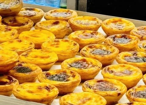 Assorted mini tarts with fruit and chocolate topping on a tray Stock Photos