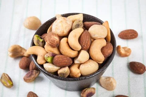 Assorted mixed nuts in bowl on the table Stock Photos