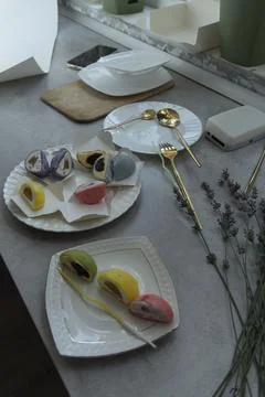 Assorted Mochi Desserts on Table with Gold Cutlery and Lavender Stock-Fotos