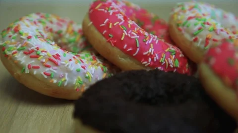 Assorted multicolored donuts lie on the table. Stock Footage 90303362