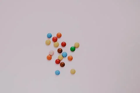 Assorted multicolored sweets dragee on a pink background Stock Photos