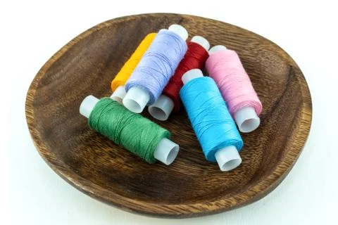 Assorted multicolored threads skein of green, blue and pink folded in a woode Stock Photos