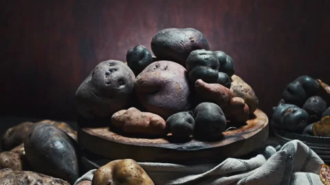 Assorted native Peruvian potatoes and purple chips in a rustic setting. Stock-Footage 339078499