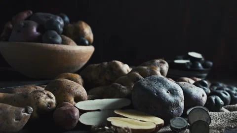 Assorted native Peruvian potatoes and purple chips in a rustic setting. Stock Footage 341440646