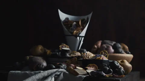Assorted native Peruvian potatoes and purple chips in a rustic setting. Stock Footage 341440692