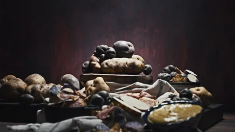 Assorted native Peruvian potatoes and purple chips in a rustic setting. Video stock 341440698