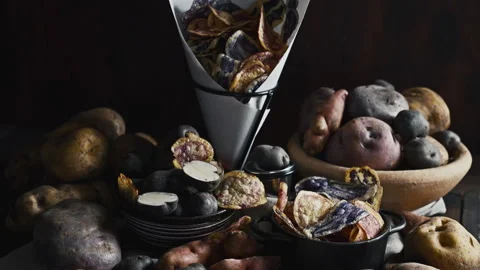 Assorted native Peruvian potatoes and purple chips in a rustic setting. Stock Footage 341440707