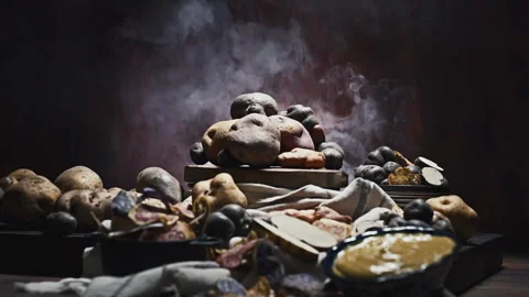 Assorted native Peruvian potatoes and purple chips in a rustic setting. Video stock 341440753