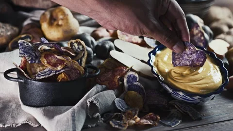 Assorted native Peruvian potatoes and purple chips in a rustic setting. Stock-Footage 344986780