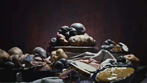 Assorted native Peruvian potatoes and purple chips in a rustic setting. 動画素材 344987063