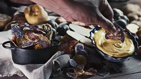 Assorted native Peruvian potatoes, purple chips and Huancaina dip. Stock Footage 341440668