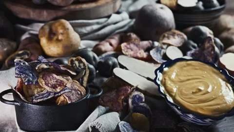 Assorted native Peruvian potatoes, purple chips and Huancaina dip. Video stock 341440670