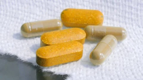 Assorted Natural Herbal Supplement Capsules and Tablets on White Stock-Footage 330387770