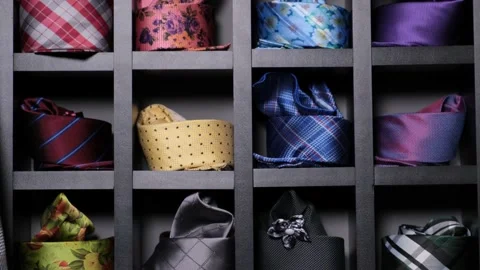 Assorted neckties or ties on display at store. Rows of hanging colorful ties in Stock Footage 142682750