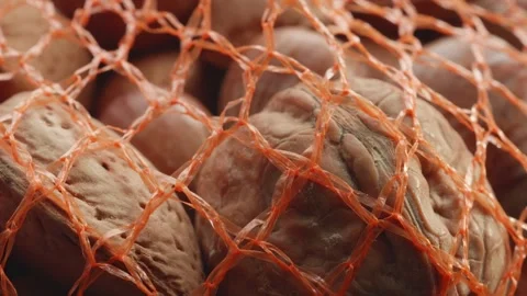 Assorted netted shelled nuts extreme close up stock footage Видео 310938609