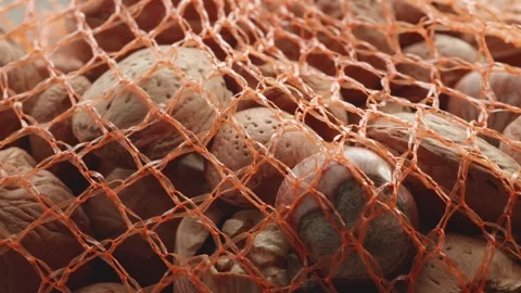 Assorted netted shelled nuts extreme close up stock footage Видео 310938853