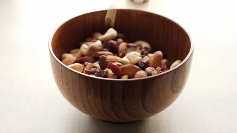 Assorted nutritious nuts cascade into bowl providing satisfying crunch. Nuts Video stock 267190750