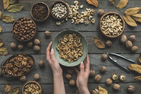 Assorted nuts and autumn leaves Stock Photos