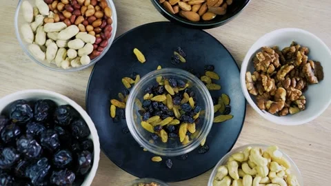 Assorted Nuts and Dried Fruits on Wooden Table Stock Footage 320725991