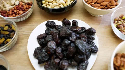 Assorted nuts and dried fruits on a wooden table Stock Footage 320726414