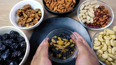 Assorted nuts and dried fruits in bowls Stock Footage 320727422