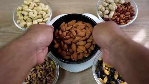 Assorted Nuts in Bowls on Wooden Table Stock Footage 320726977