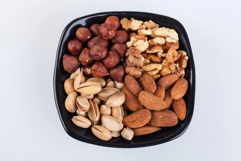 Assorted nuts in ceramic bowl Stock Photos