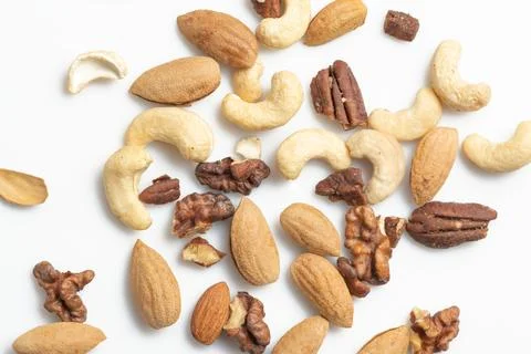 Assorted nuts mix on white background: cashews, almonds, pecans, and walnuts Stock Photos