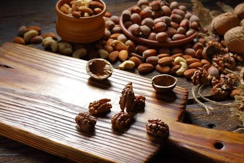 Assorted Nuts on Rustic Wooden Board Stock Photos