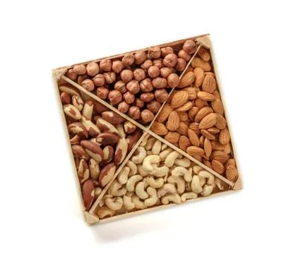 Assorted nuts. Set of nuts top view. Isolated on white background. Wooden box Stock Photos