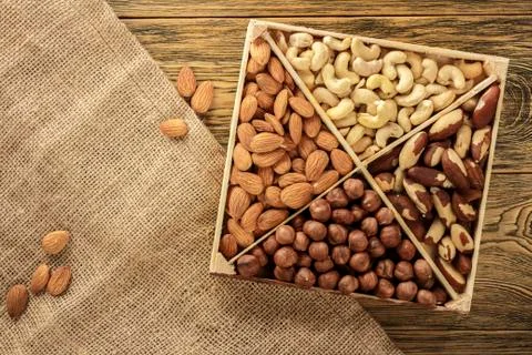 Assorted nuts. Set of nuts top view. Wooden table, rustic style. Place for te Stock Photos