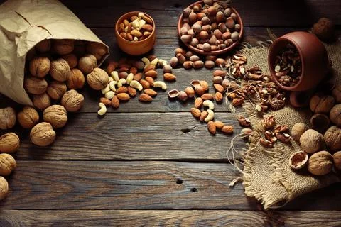 Assorted nuts spilled on wooden table 写真素材
