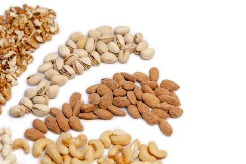 Assorted nuts on white background. Walnuts almonds pistachios cashews Foto stock