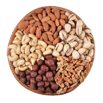 Assorted nuts in a wicker bowl Stock Photos