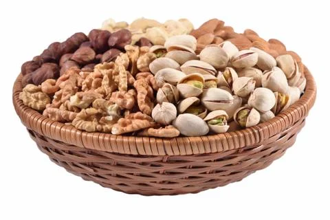 Assorted nuts in a wicker bowl on a white background Stock Photos