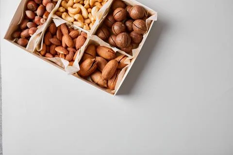 Assorted nuts in a wooden box nuts: pecan, almond, macadamia, brazil, cashew, Stock Photos