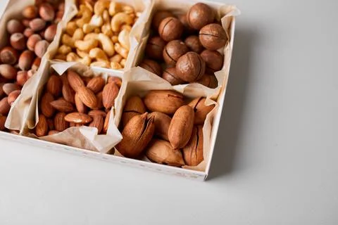 Assorted nuts in a wooden box nuts: pecan, almond, macadamia, brazil, cashew, Stock Photos
