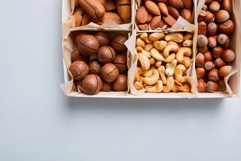 Assorted nuts in a wooden box nuts: pecan, almond, macadamia, brazil, cashew, Stock Photos