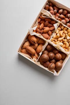 Assorted nuts in a wooden box nuts: pecan, almond, macadamia, brazil, cashew, Stock Photos