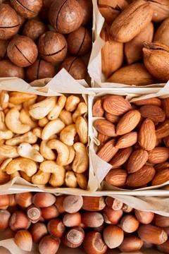 Assorted nuts in a wooden box nuts: pecan, almond, macadamia, brazil, cashew, Stock Photos