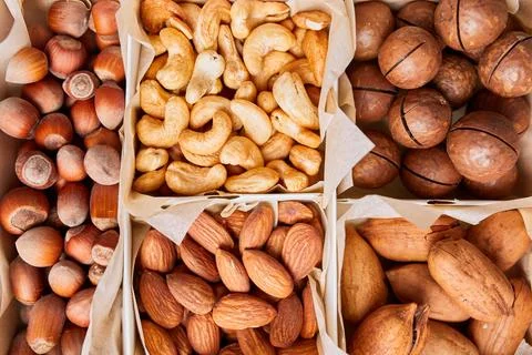 Assorted nuts in a wooden box nuts: pecan, almond, macadamia, brazil, cashew, Stock Photos