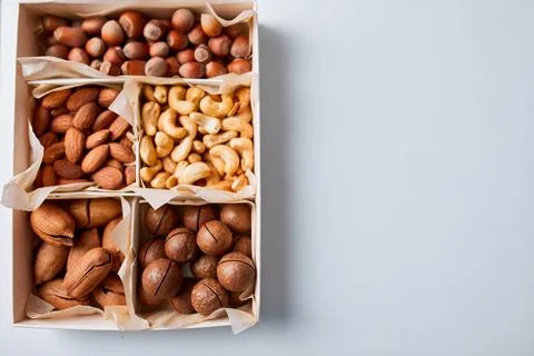 Assorted nuts in a wooden box nuts: pecan, almond, macadamia, brazil, cashew, Stock Photos