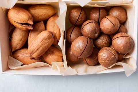 Assorted nuts in a wooden box nuts: pecan, almond, macadamia, brazil, cashew, Stock Photos